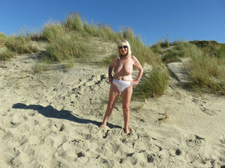 Bare senior female in the dunes